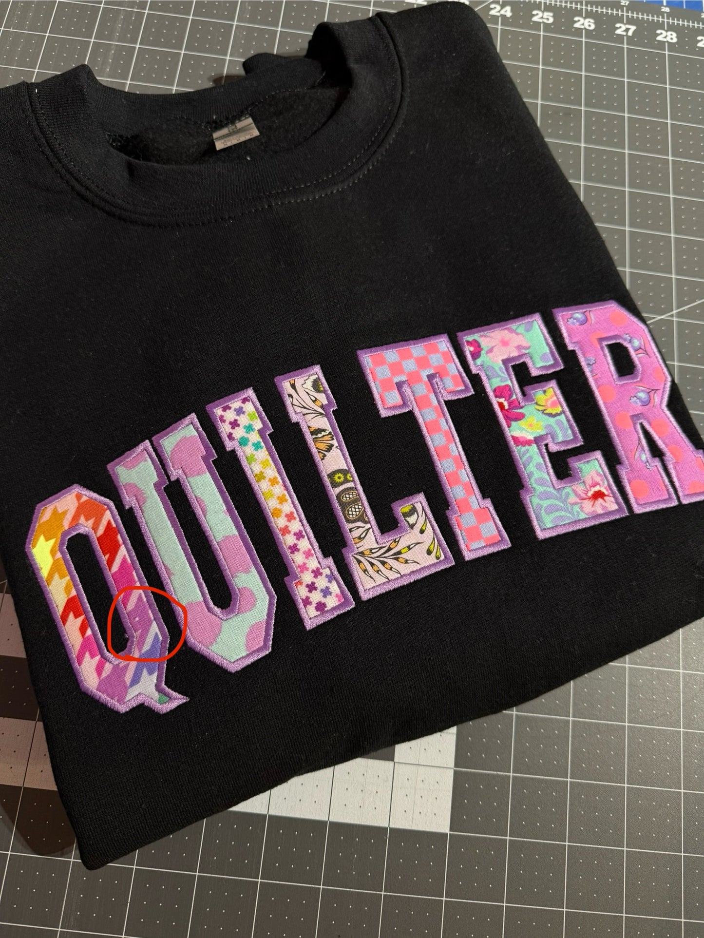 Black Medium QUILTER crewneck - OUPS (small missing print spot)
