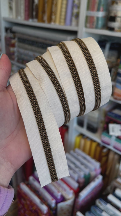 Cream - Antique Brass Coil Zipper Tape # 5 Zipper (1 Meter)